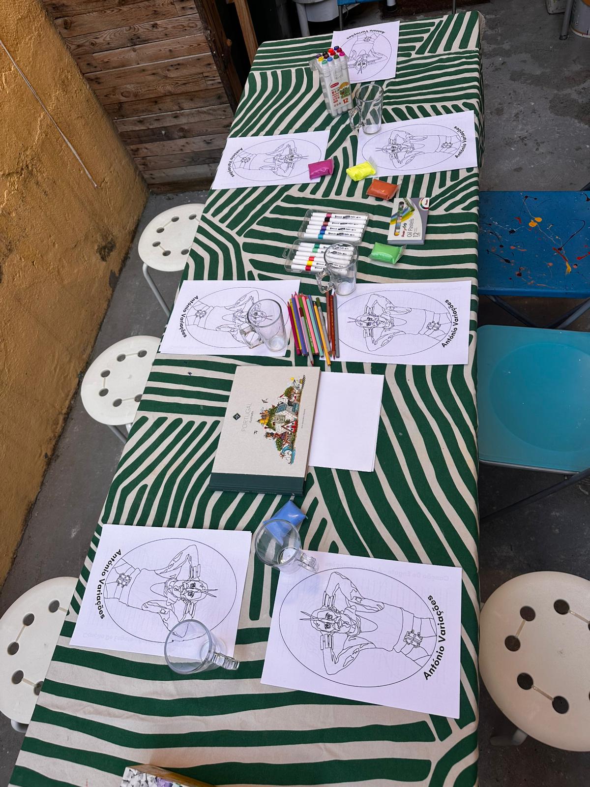 Long table set up for a colouring event with green stripes